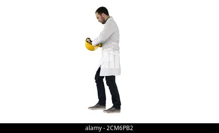Young construction engineering student walking and putting cap o Stock Photo
