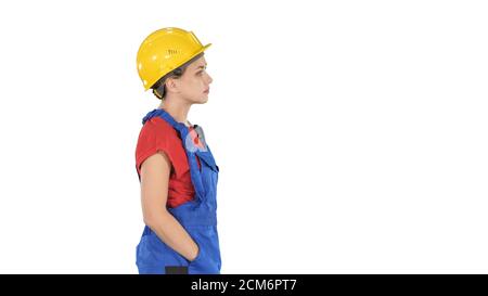 Construction worker lady walking emotionless on white background Stock Photo
