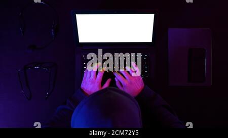 Hacker hacking system on a laptop. White Display. Stock Photo
