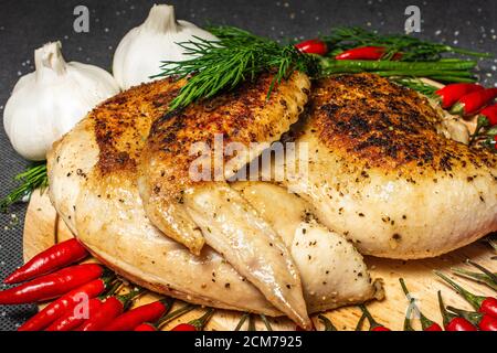 fried chicken, roasted half chicken, served vegetable, yummy, sprinkled with spices, garlic and red hot mini pepper Stock Photo