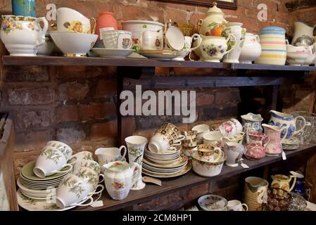 A selection of cups saucers and tea sets for sale in an antiques centre in Leominster, Herefordshire Stock Photo