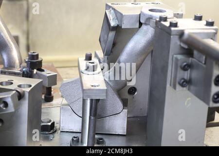 iron casting pipes were clamped on jig , ready for machining process by CNC machine Stock Photo