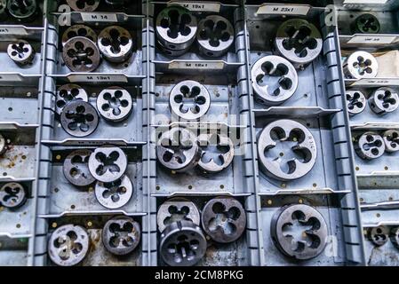 different size sorted Thread cutting die tool, a photo close up. Industrial abstract background. Stock Photo