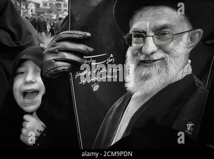 Tehran,Iran - February 11,2008 - Iranian Supreme Leader Khamenei's child carrying a banner. Stock Photo