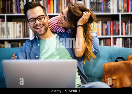 Couple relaxing together in sofa with computer pc having fun. Stock Photo