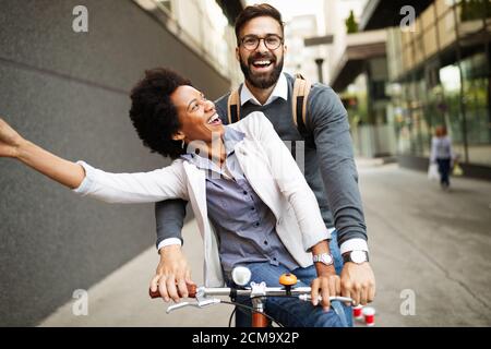 Young couple having fun in the city and ride a bicycle Stock Photo