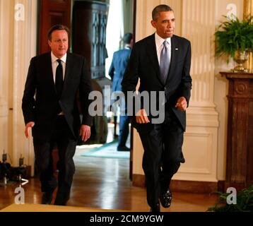 Britain's Prime Minister David Cameron and U.S. President Barack Obama arrive at a joint news conference in the East Room of the White House in Washington, May 13, 2013. REUTERS/Jim Bourg (UNITED STATES - Tags: POLITICS)