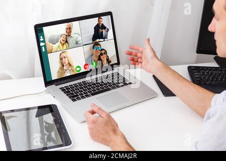 Businessman Video Conferencing With His Colleagues On Laptop On Desk In Office Stock Photo