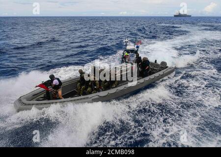 1076 PHILIPPINE SEA (Sept. 16, 2020) A visit, board, search and seizure team from the amphibious transport dock ship USS New Orleans (LPD 18)  approaches a simulated suspect vessel during a training exercise. New Orleans, part of the America Amphibious Ready Group assigned to Amphibious Squadron 11, along with the 31st Marine Expeditionary Unit, is operating in the U.S. 7th Fleet area of responsibility to enhance interoperability with allies and partners and serve as a ready response force to defend peace and stability in the Indo-Pacific region. (U.S. Navy photo by Mass Communication Speciali Stock Photo