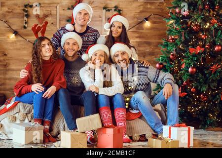 Cheerful friends with gifts celebrating Christmas Stock Photo