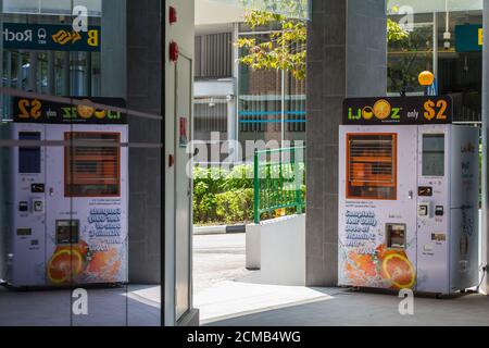 Orange juice vending machine station, the machine squeeze out fresh orange juice for the consumer. The machine also transfer data when oranges is out. Stock Photo