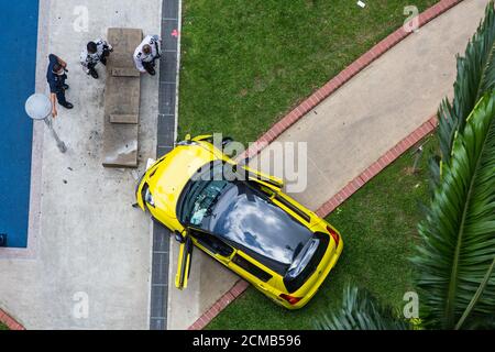Aerial view of a yellow/black Suzuki vehicle crash onto the pedestrian walkway resulted in a freak accident. Causing damage to public area. Singapore. Stock Photo