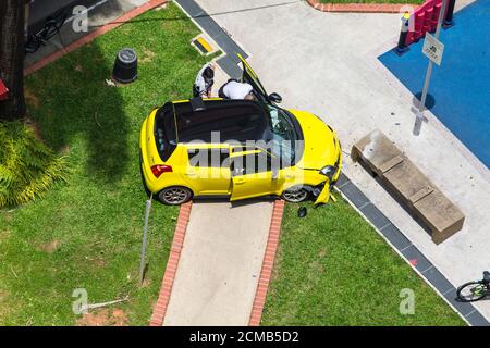 Aerial view of police officers are checking the interior of an accident car on the pavement.Singapore. Stock Photo