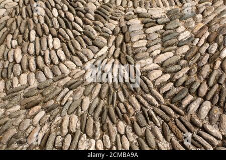 Textured background, old vintage pavement with round stones and cobbles top view Stock Photo