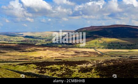 Scenic upland countryside (Wharfedale valley, Simon's Seat peak, high hills, fells, sunlight, shadows on land, blue sky) - Yorkshire Dales, England UK Stock Photo
