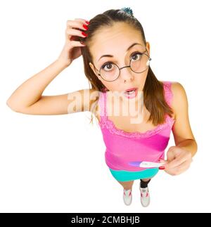 Funny schoolgirl in nerd glasses with positive pregnacy test isolated Stock Photo