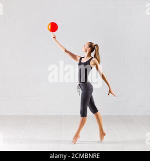 Young girl is engaged in art gymnastics Stock Photo