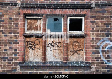 Sheffield,  UK – 30 Nov 2018 : broken and boarded up windows of a derelict empty property at 90 Trippet Lane Stock Photo