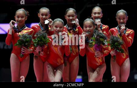 The China team celebrates after winning silver in the women's team final at the World Gymnastics Championships at the Hydro arena in Glasgow, Scotland, October 27, 2015. REUTERS/Phil Noble
