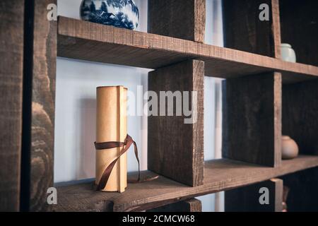 Chinese paper scroll and traditional teaware on the shelves in the tea house Stock Photo