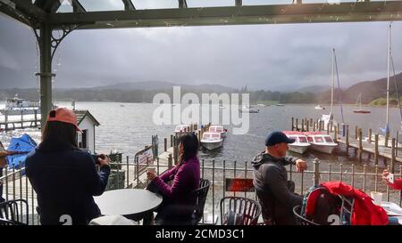 People sitting on cafe terrace at Lake Windermere Stock Photo