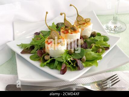 Cheese and capers sweet and sour sauce and pistachios Stock Photo