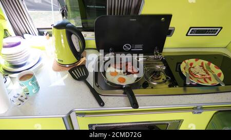 Cooking breakfast in campervan Stock Photo