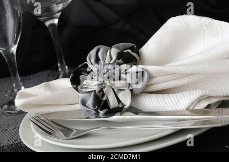 Decorative folded napkin on a plate with cutlery Stock Photo