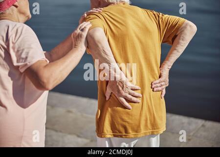 Caucasian male pensioner experiencing an acute backache Stock Photo