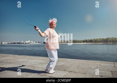 Sporty woman working out on the quay Stock Photo