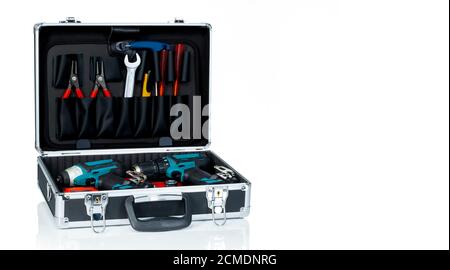 Toolbox isolated on white background. Black toolbox with tools. Pliers, spanner or wrench, screwdriver, cutter, and cordless driver drill in tool case Stock Photo