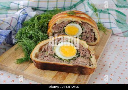 Meatloaf with egg and greens in the test Stock Photo