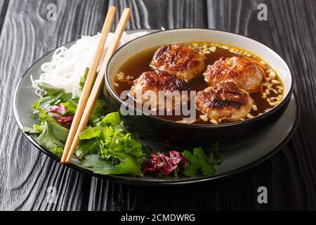 Vietnamese Grilled Pork Meatballs with Vermicelli Noodles Bun Cha is a classic Northern Vietnamese dish closeup in the plate on the table. Horizontal Stock Photo