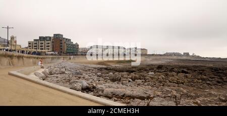 A sweeping view along the newly re built promenade at Porthcawl showing the grand Pavilion and shops all the way across to the harbour and quay. Stock Photo