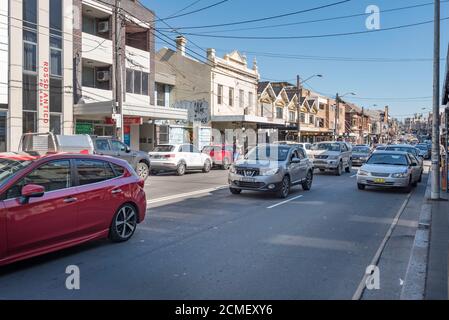 Normal day time weekend traffic on King Street in the inner city suburb of Newtown in Sydney, Australia Stock Photo