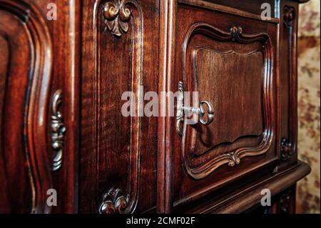 Key and door to an old wooden cabinet Stock Photo