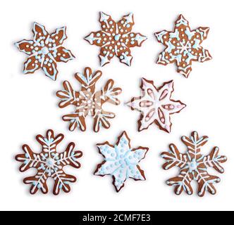 Homemade snowflake shaped gingerbread cookies with sugar icing, on white background isolated Stock Photo
