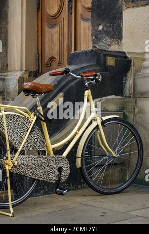 of old yellow bicycle. leather seat with shock absorbers and wheel Stock Photo