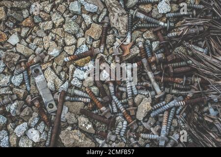 Pile of screws and bolts on the ground Stock Photo