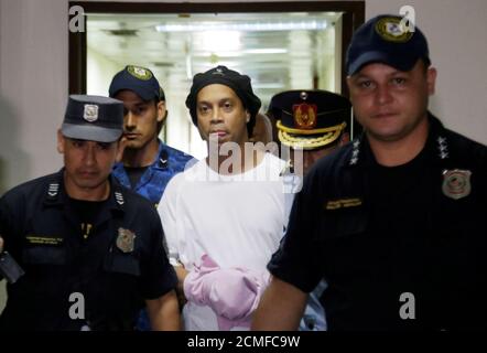 Judge rules Ronaldinho must remain in Paraguayan jail - Paraguayan Supreme Court, Asuncion, Paraguay - March 7, 2020? Ronaldinho handcuffed and escorted by police at the Supreme Court of Paraguay?REUTERS/Jorge Adorno