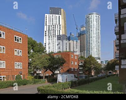 New residential towers appear above older low-rise council blocks amid in Vauxhall, London, UK, an area undergoing massive redevelopment. Stock Photo