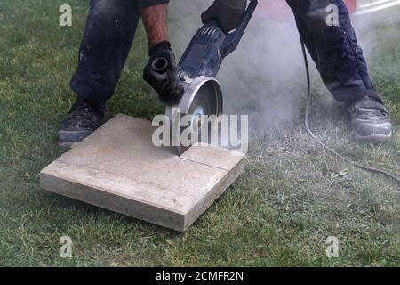 Industrial construction worker using a professional angle grinder Stock Photo