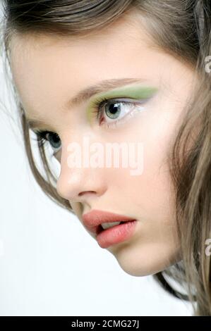 The face of a young girl with bright makeup on eyes. Stock Photo