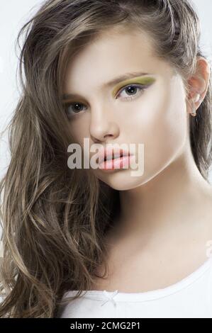 Beauty portrait of a young girl with bright makeup and long hair. Stock Photo