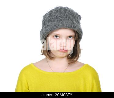 Portrait of resentful teenager in funny hat knitted jumper and bright. Stock Photo