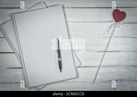 Open notebook in the small cell with a pen Stock Photo