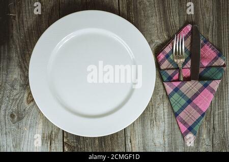 Empty plate with cutlery on a gray wooden table Stock Photo