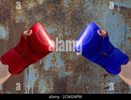Two female hands in red and blue boxing gloves Stock Photo