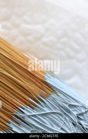 Close up view of well used paintbrush with pale blue paint and negative space for copy Stock Photo