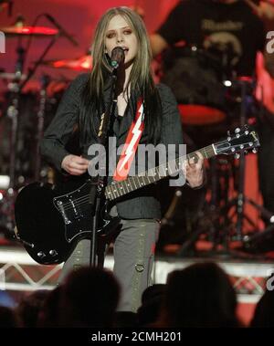 Singer Avril Lavigne performs her song 'Don't Tell Me' at the Nickelodeon 17th annual Kids' Choice Awards, is shown in one of her many costume changes during the show in Los Angeles April 3, 2004. The show features favorite music, film and television stars as they receive awards chosen by the children themselves. REUTERS/Fred Prouser PP04040007  REUTERS